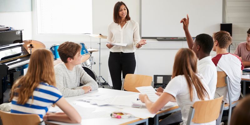 A classroom scene with students discussing ethical topics, led by a teacher