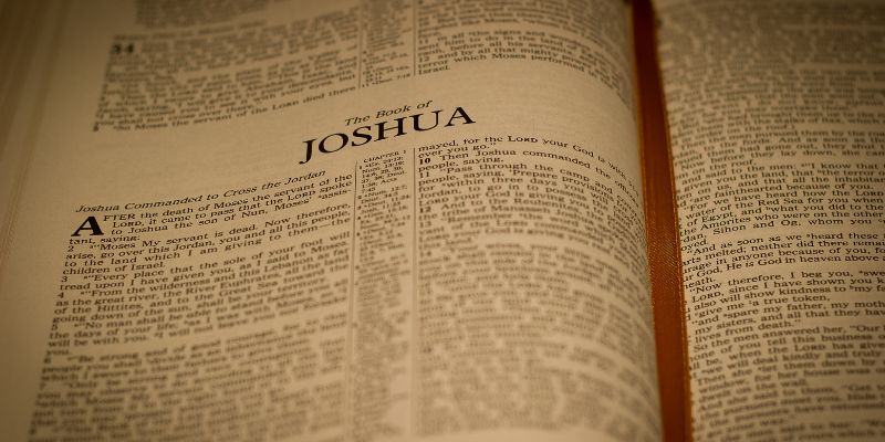 A serene, reflective image of a Bible with a verse (such as Joshua 24-15)